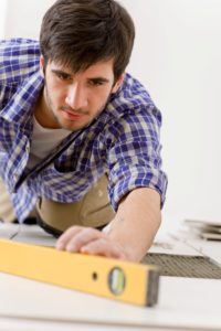 Tile Installer Checks Floor Level